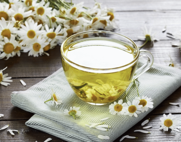 Asian ginseng roots and chamomile flowers displayed side by side on a wooden table, symbolizing natural stress relief and immune support